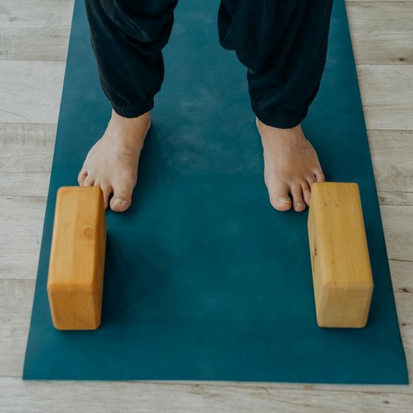 Minimalist yoga mat and blocks in a clean room.
