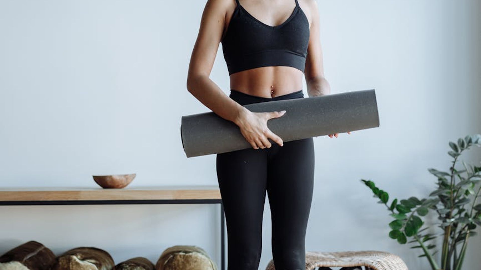 Person practicing yoga in a bright morning studio.