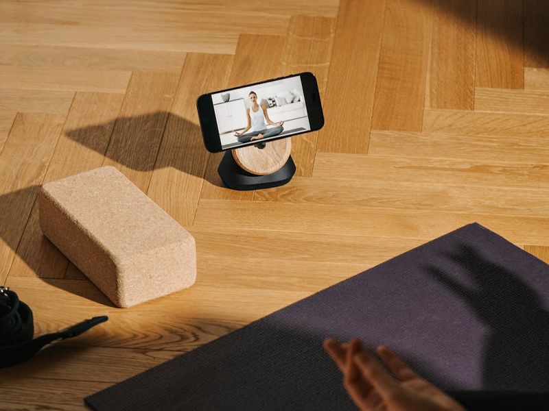 Yoga equipment on a wooden floor in a studio.